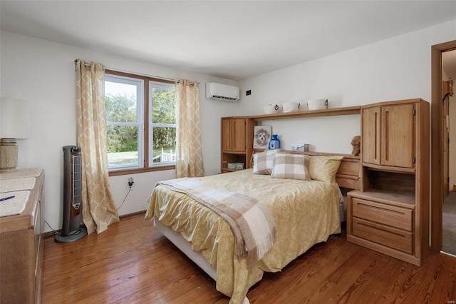 bedroom with dark wood-type flooring and a wall unit AC