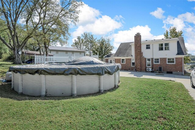 exterior space with a covered pool and a patio area