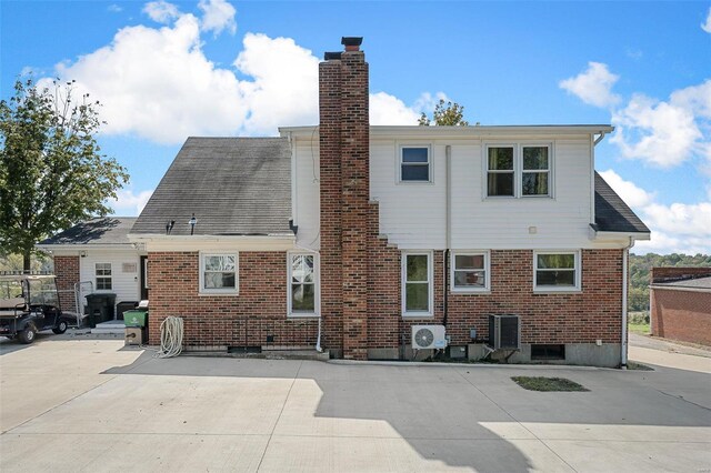 rear view of property with a patio and central AC