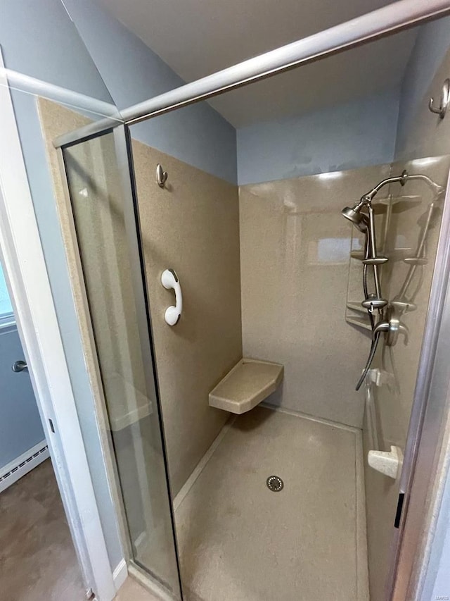 full bath featuring a stall shower and a baseboard radiator