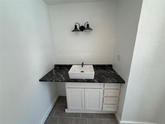 bathroom featuring tile patterned floors, vanity, and baseboards
