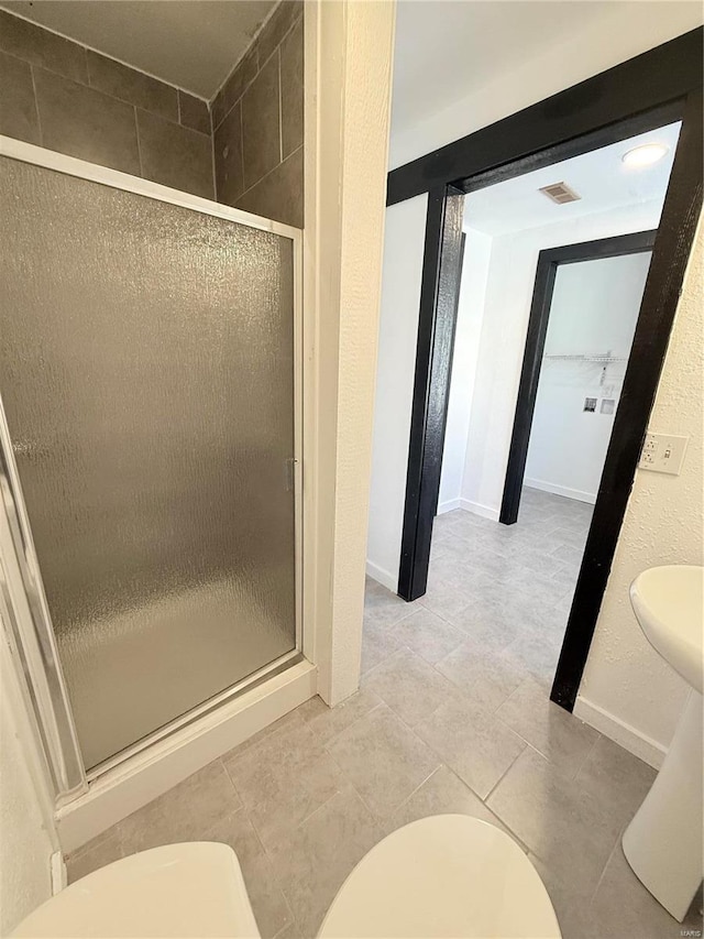 full bath with a shower stall, tile patterned flooring, visible vents, and toilet