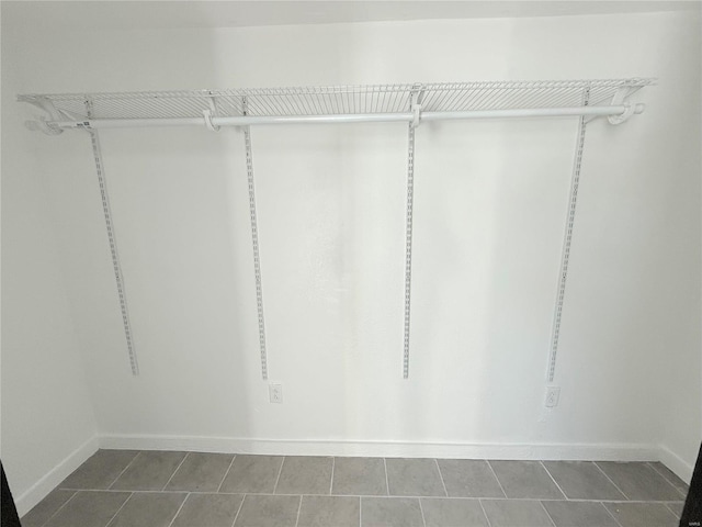 spacious closet with tile patterned floors