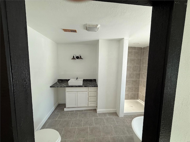 full bath with a shower stall, vanity, tile patterned flooring, visible vents, and baseboards