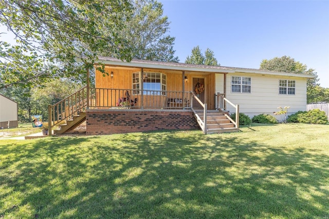 ranch-style home with a front lawn and a porch