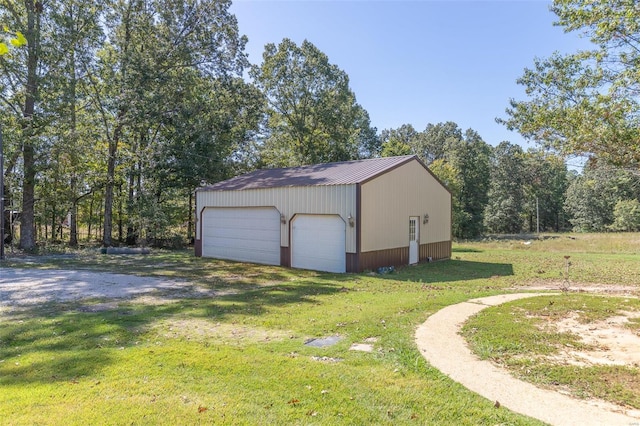 view of outdoor structure with a yard and a garage