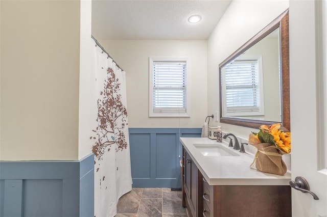 bathroom featuring a textured ceiling and vanity