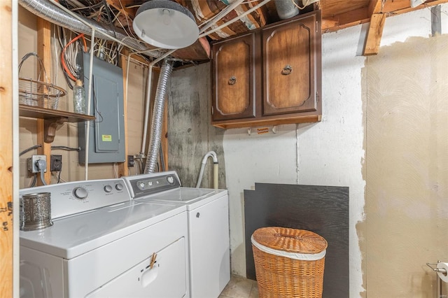 washroom with washer and clothes dryer, cabinets, and electric panel