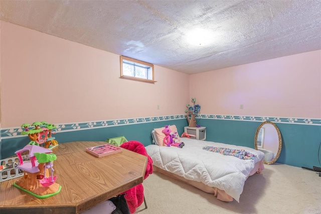 bedroom with a textured ceiling and carpet flooring