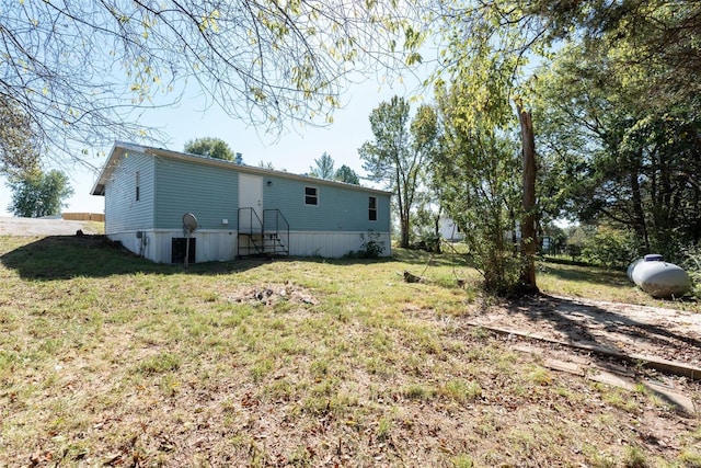 rear view of house featuring a yard