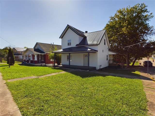 view of front of property featuring covered porch and a front yard