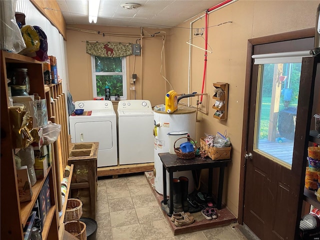 washroom featuring water heater and washer and dryer