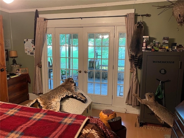 interior space with crown molding, french doors, and hardwood / wood-style flooring