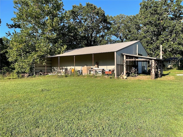 exterior space featuring a lawn and an outbuilding