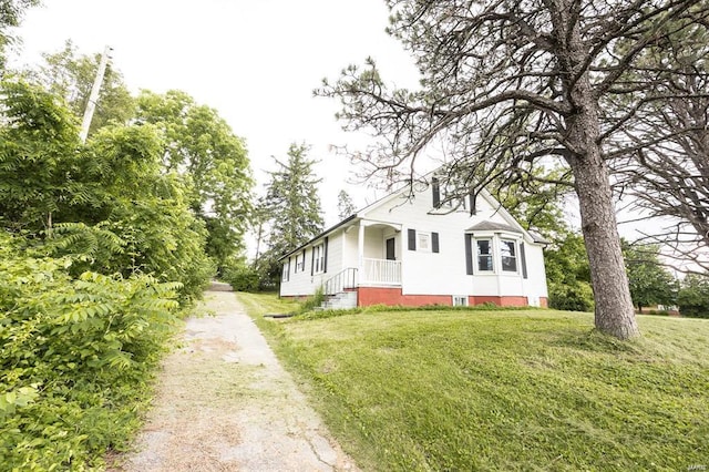 view of side of home featuring a yard