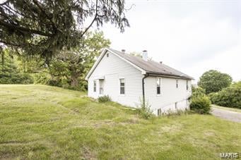 view of property exterior featuring a yard