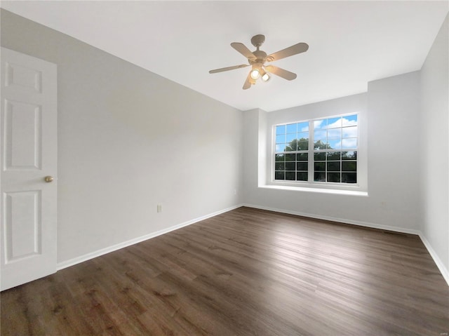 unfurnished room featuring ceiling fan and dark wood-type flooring