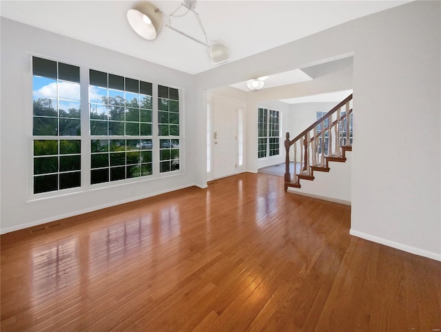 interior space with wood-type flooring and an inviting chandelier