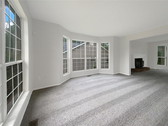 unfurnished living room featuring carpet flooring