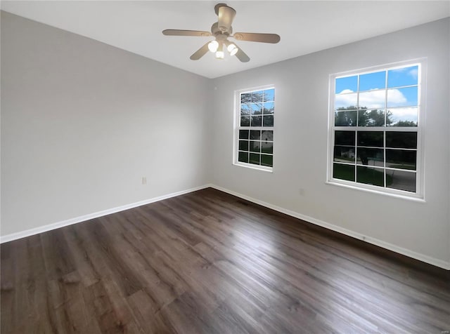 unfurnished room with ceiling fan and dark hardwood / wood-style flooring