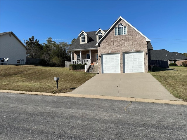 view of front of house with a front yard, a porch, and a garage