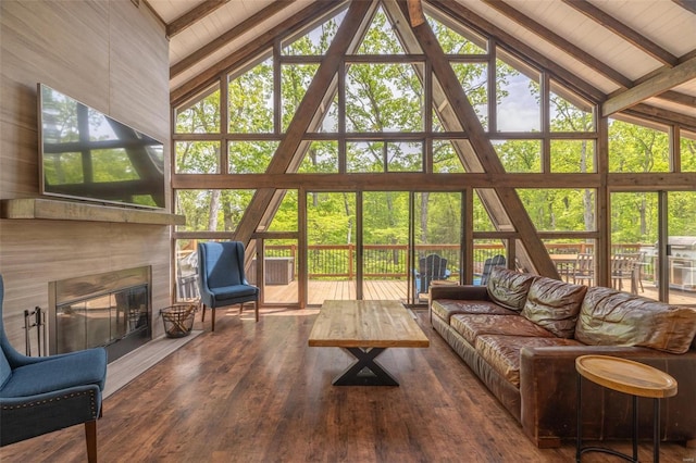 living room featuring high vaulted ceiling, a healthy amount of sunlight, beamed ceiling, and hardwood / wood-style floors