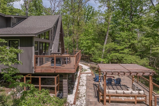 back of property featuring a wooden deck, an outdoor hangout area, and a patio