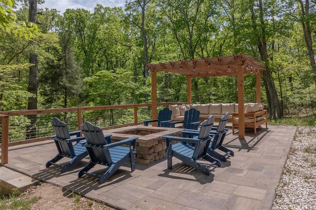 view of patio with an outdoor living space with a fire pit