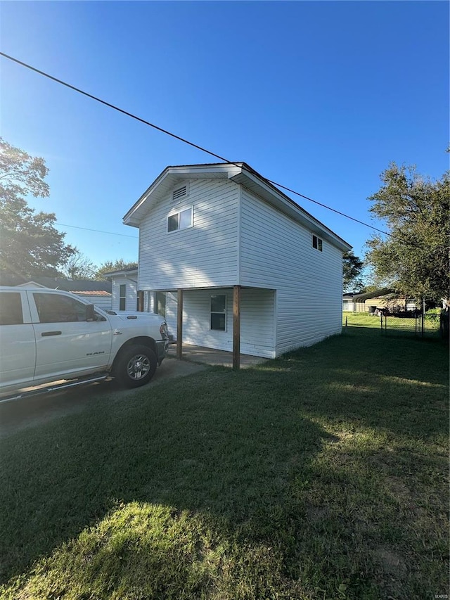 view of side of property with a yard