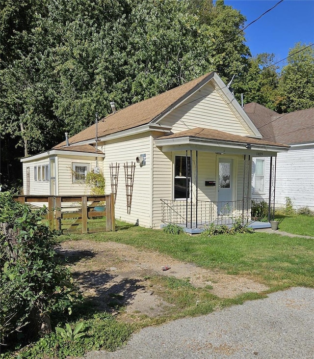 bungalow-style home with a front lawn