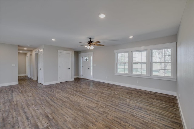 unfurnished living room with ceiling fan and dark hardwood / wood-style flooring