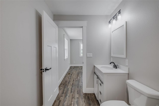 bathroom featuring hardwood / wood-style flooring, vanity, and toilet