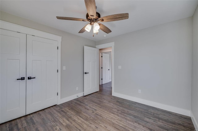 unfurnished bedroom with a closet, ceiling fan, and dark hardwood / wood-style floors