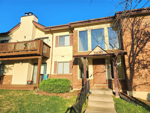 exterior space featuring a balcony and a front yard