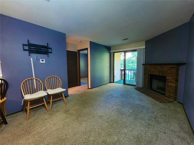 carpeted living room with a textured ceiling and a fireplace