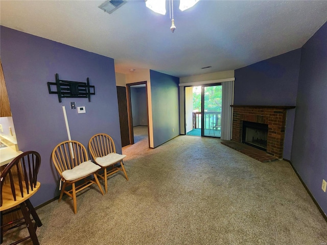 sitting room with carpet floors and a brick fireplace