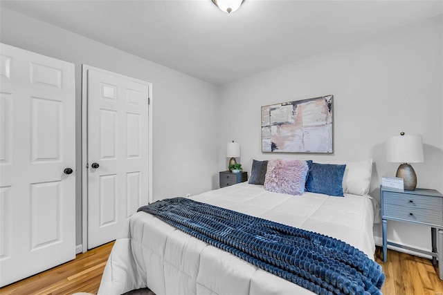 bedroom with wood-type flooring