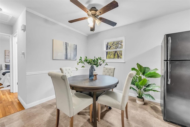 dining room featuring crown molding, ceiling fan, and light wood-type flooring