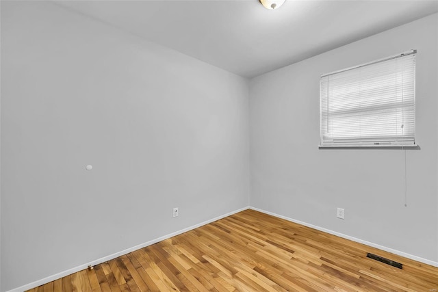 spare room featuring hardwood / wood-style flooring