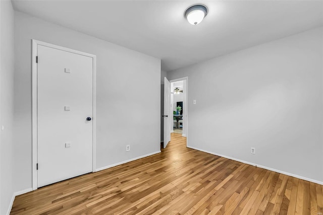 spare room featuring light wood-type flooring and ceiling fan