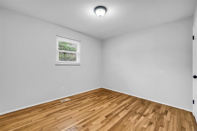 spare room with light hardwood / wood-style floors