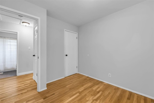 unfurnished bedroom with light wood-type flooring