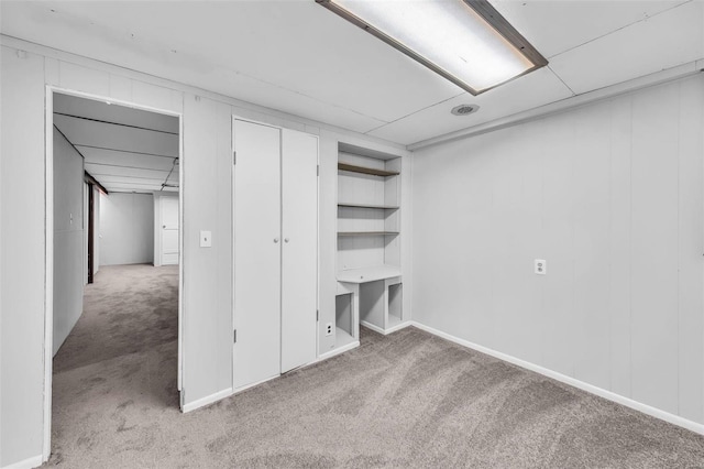 basement featuring light colored carpet