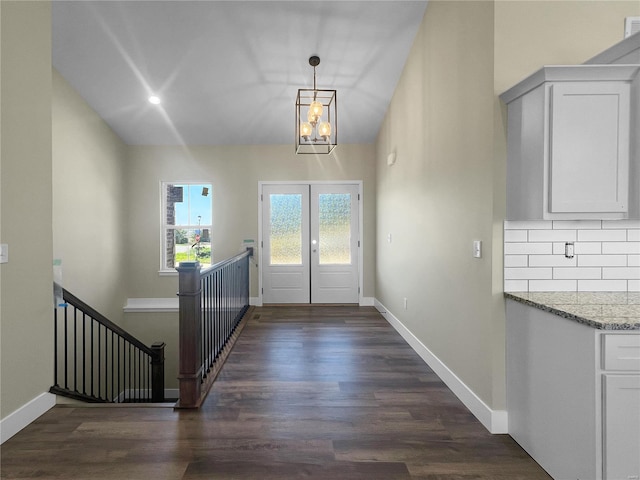 doorway to outside featuring a chandelier, french doors, and dark hardwood / wood-style flooring