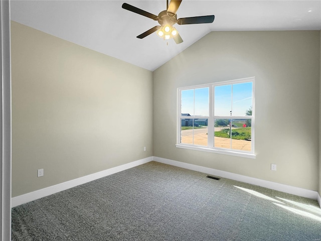 carpeted spare room with ceiling fan and vaulted ceiling