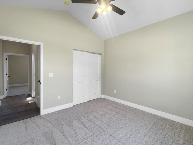 unfurnished bedroom featuring ceiling fan, a closet, carpet flooring, and high vaulted ceiling