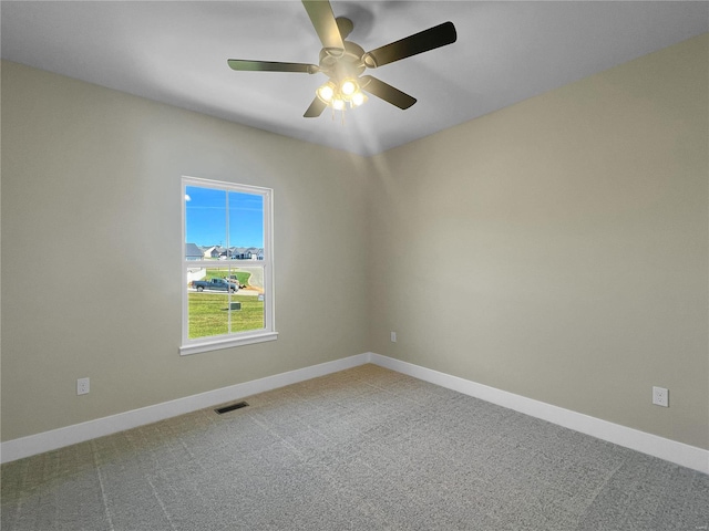 carpeted spare room with ceiling fan