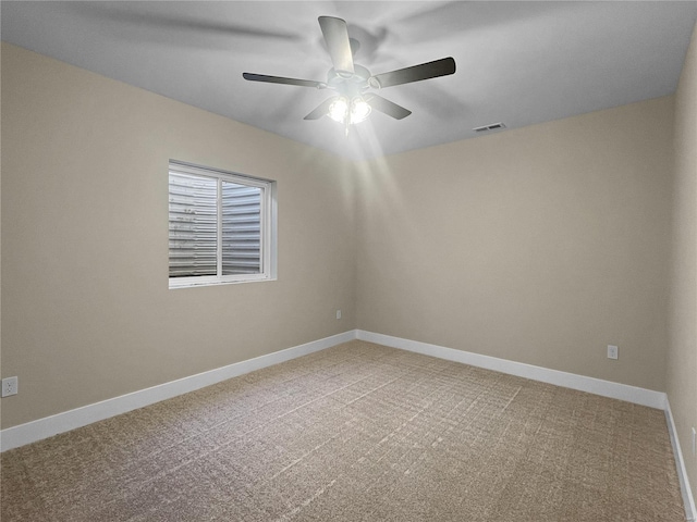 carpeted spare room featuring ceiling fan