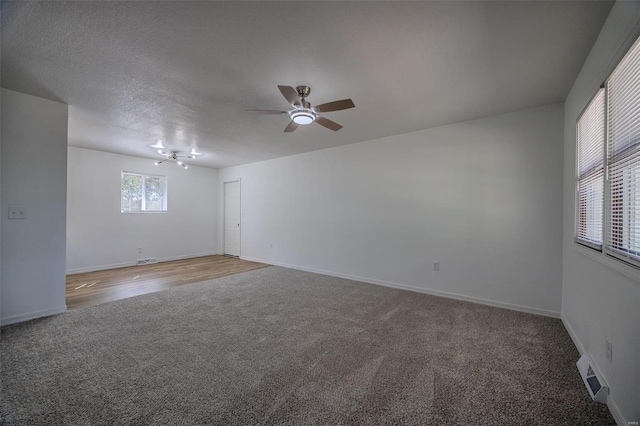 empty room with hardwood / wood-style floors, a textured ceiling, and ceiling fan