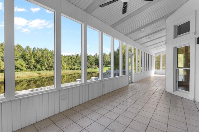 unfurnished sunroom with a water view, ceiling fan, and a healthy amount of sunlight